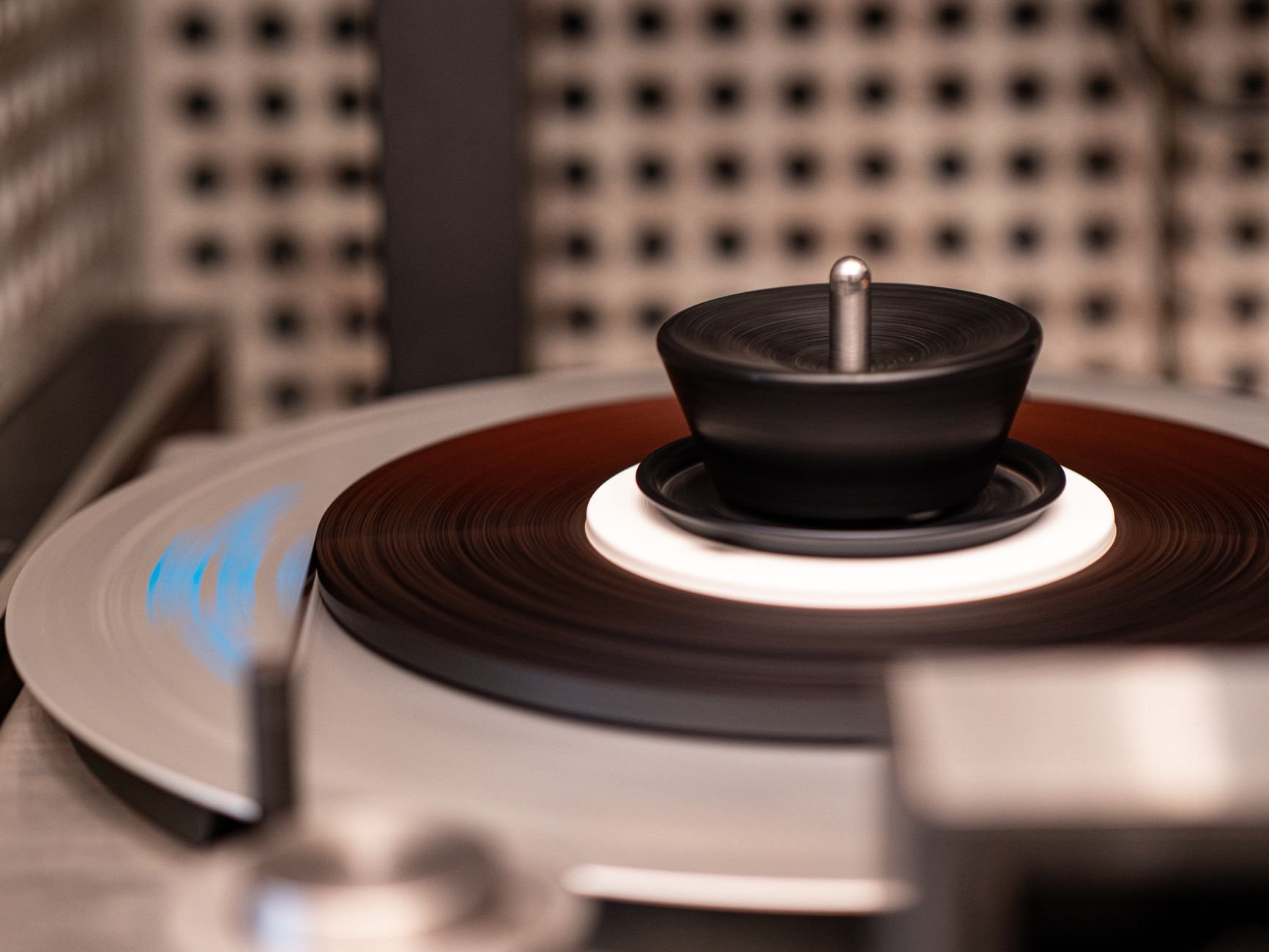 Detailed close-up of a vintage record player spinning a vinyl disc indoors.